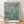 Serene impressionist painting of delicate almond blossoms on branches against a soft teal blue background, rendered in cream white, olive green, and golden tan tones.