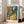 Tranquil landscape poster showing verdant trees and garden setting in golden and olive tones characteristic of 1889 Impressionist work.