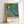 Framed impressionist poster showcasing Van Gogh's iconic iris composition with rich purples and orange accents, perfect for gallery-style wall decor.