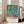 Serene flower garden print featuring irises rendered in Van Gogh's distinctive swirling technique with cream and purple harmonies, hung as elegant wall art.