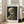 Skeleton skull holding cigarette rendered in impressionist brushwork with cream, olive, and dark grey hues, displayed as a framed poster.
