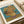 Framed poster showcasing Van Gogh's iconic 1888 sunflower still life with bold yellows, dusty rose, and teal tones, capturing the warmth and expressive beauty of this Impressionist treasure.