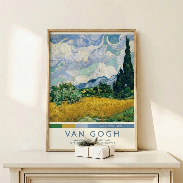 Dramatic impressionist wall art of a golden grain field lined with tall dark cypresses, misty mountains, and a deeply textured, swirling sky in blues and creams.