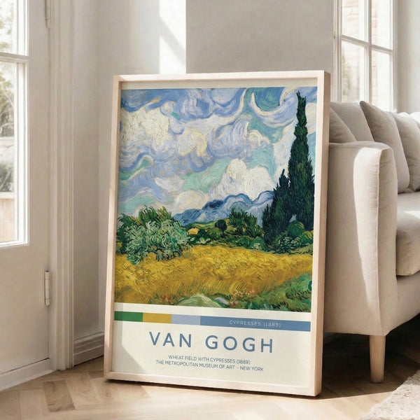 Moody impressionist poster showing a wheat field in golden tones with emerald cypress trees, slate mountains, and an emotionally turbulent sky with sweeping brushwork.