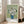 Tranquil impressionist study of white blooms in blue ceramic vase against soft cream and pale green tones, elegant wall poster.