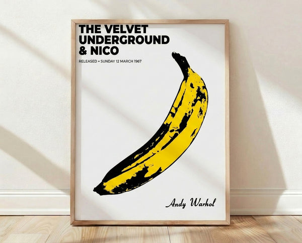 Framed pop art poster featuring a bold yellow banana on a contrasting background, iconic 1960s album artwork in vibrant minimalist style.