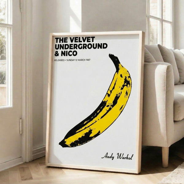 Framed contemporary pop art print showing a stylized yellow banana, bold graphic design in the spirit of classic album cover art.