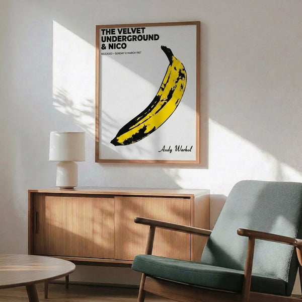 Framed pop art poster with a luminous yellow banana as its central motif, simple yet striking graphic design from 1960s music culture.