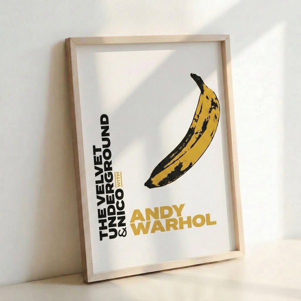 Framed pop art poster featuring a simplified banana in vibrant yellow tones against neutral cream, epitomizing 1960s avant-garde design.