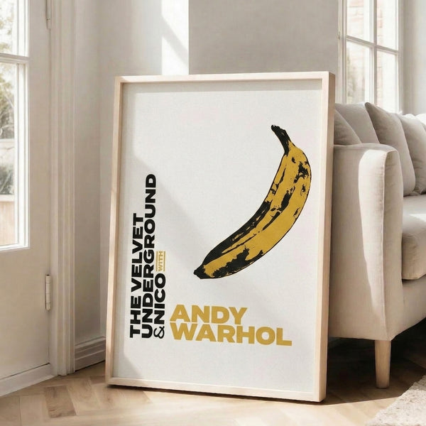 Cream and yellow pop art banana poster framed on wall, capturing the iconic Velvet Underground aesthetic in modern minimalist style.