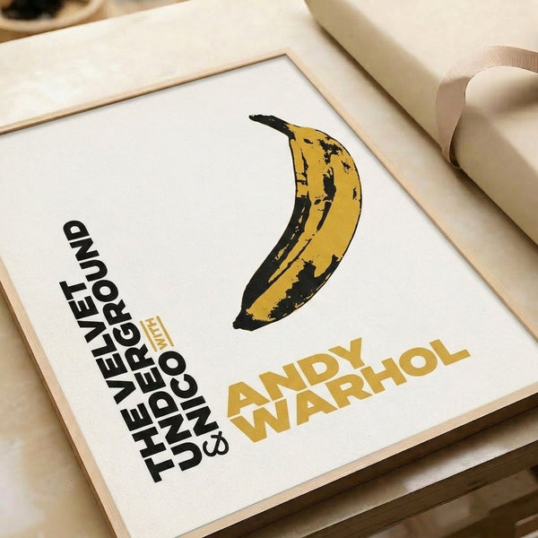 Minimalist pop art framed poster showcasing a bright yellow banana against cream, inspired by Warhol's groundbreaking Velvet Underground era.