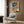 Energetic New Orleans jazz street scene wall art in retro pop art aesthetic, featuring a trumpet player amid potted plants and doors with vivid teal, purple, orange, and lime accents.