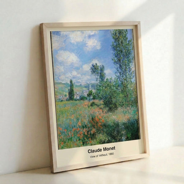 Framed art print showing Monet's contemplative view of a rural landscape with blooming poppies, tall poplar trees, and a cream-and-blue village scene.