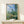 Impressionist masterpiece capturing a sunlit poppy field with rolling greens, a church tower, and atmospheric golden tones in this 1880 Vetheuil composition.