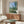 Wall art print of Monet's peaceful 1880 scene: a poppy-dotted field with distant poplars and village buildings rendered in serene Impressionist style.