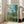 Serene impressionist view of Vetheuil village reflected in calm water, painted with soft, atmospheric brushwork in a range of muted and vibrant hues.