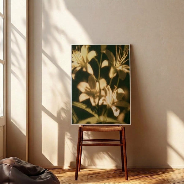 Soft impressionist floral artwork displaying pale yellow lilies with rich green accents and warm brown undertones, mounted as a framed wall print with gentle, nostalgic charm.