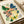 Elegant framed botanical print combining watercolor techniques with a butterfly motif among vintage flowers in navy, coral, yellow, and green tones on a soft cream background.