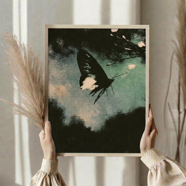 Nostalgic botanical art print inspired by Japanese woodblock technique, depicting a moth in serene forest green and pale blue hues with cream accents, framed on a wall.