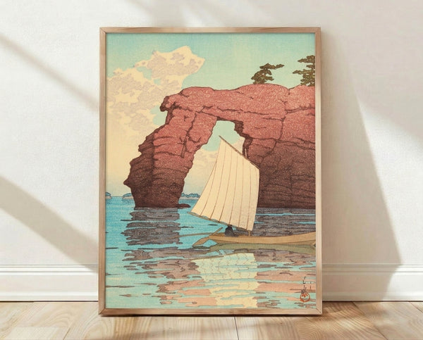 Vintage sailboat navigating beneath a dramatic red rock arch in calm turquoise waters, framed coastal art print in soft mint green, cream, and terracotta tones.