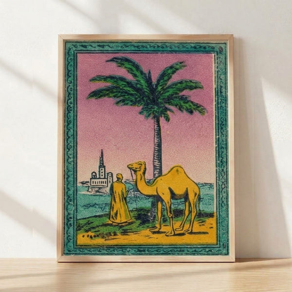 Vintage desert scene print featuring a camel, palm tree, and mosque in warm mauve, sage green, and golden tones; framed poster with nostalgic, exotic aesthetic.
