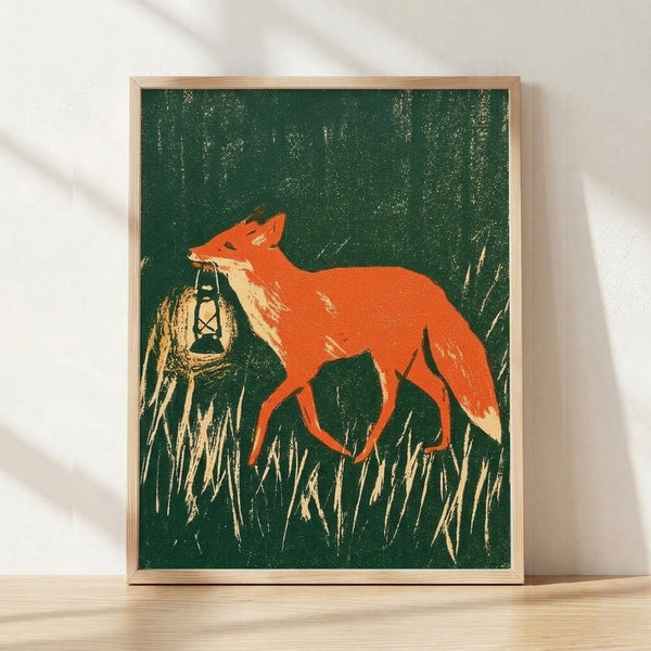 Framed folk art print depicting a russet fox holding a glowing lantern in an overgrown field, rendered in vintage style with forest green, burnt orange, and cream tones creating a cozy, nostalgic woodland mood.