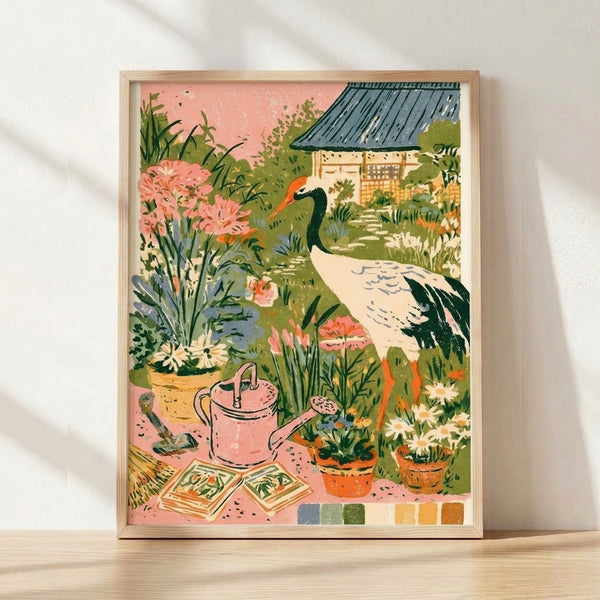 Framed watercolor poster of a red-crowned crane in a cottage garden surrounded by blooming flowers, potted plants, and a watering can in soft blush pink, sage green, and cream tones.