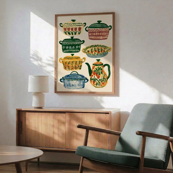 Hand-illustrated kitchen folk art poster in warm vintage palette of golden yellow, forest green, and terracotta featuring decorative pots, pitchers, and botanical elements; framed.