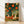 Vintage cottagecore poster depicting whimsical rabbits celebrating among glowing lanterns and flower baskets in a garden setting, rendered in deep teal, burnt orange, cream, and sage green with gold accents.
