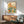 Contemporary minimalist artwork of a vintage radio adorned with floral botanical elements and birds in warm and cool tones of orange, yellow, teal, and pink.