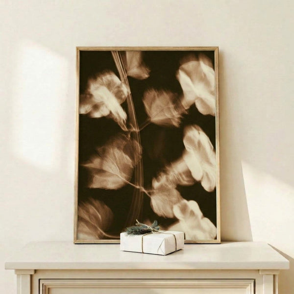 Nostalgic framed art print displaying blurred botanical leaves and flowers in warm sepia and tan tones with a gentle watercolor style that captures a cottagecore mood.