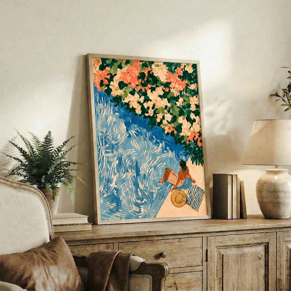 Idyllic poolside scene painted in vintage style showing a hatted woman surrounded by cascading bougainvillea in coral and vibrant greens against tranquil cobalt waters, framed as wall decor.