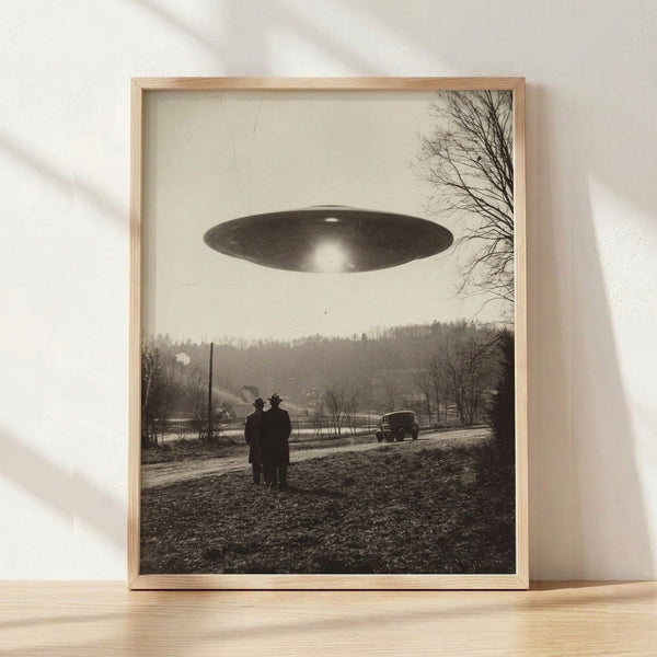 Vintage 1950s UFO sighting artwork featuring a flying saucer hovering over a rural landscape with trees, parked car, and silhouetted figures in sepia and gray tones, evoking retro sci-fi nostalgia and mysterious wonder.
