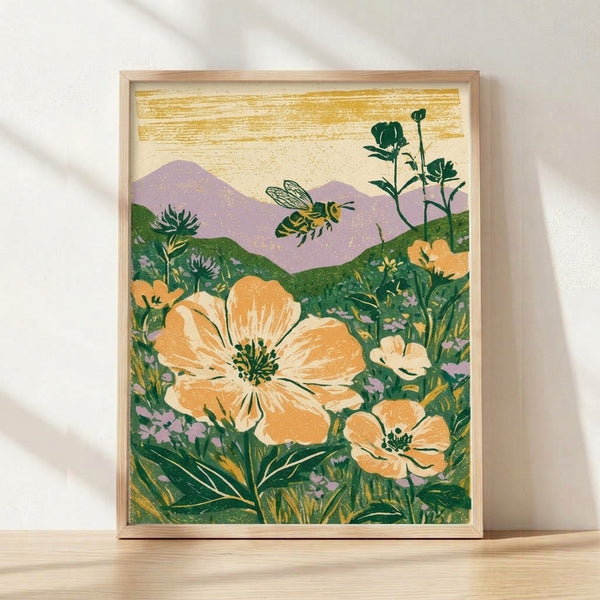Vintage-style framed poster of a bee hovering over wildflowers in a meadow, rendered in soft cream, gold, forest green, and lavender tones with warm orange-yellow accents, evoking a peaceful rustic mood.