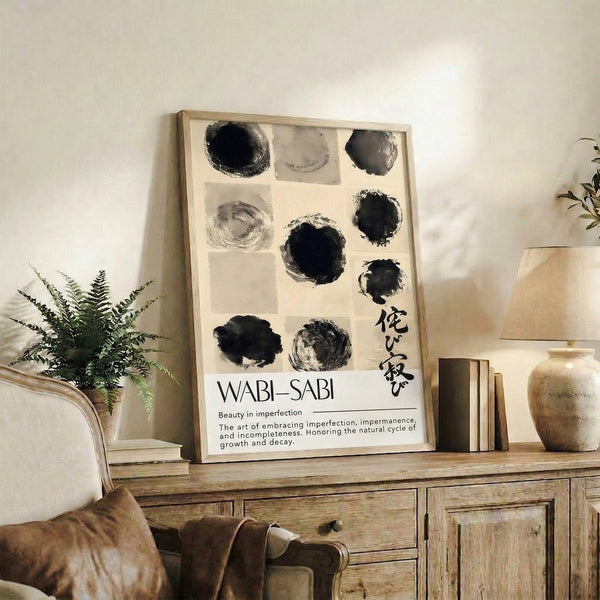 Contemplative abstract artwork with charcoal gray and black circular forms in ink on cream, embodying wabi-sabi minimalist design principles.