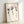 Three pressed flowers rendered in soft watercolor with charcoal stems against a cream canvas, creating a minimalist botanical composition with delicate, restful aesthetic.