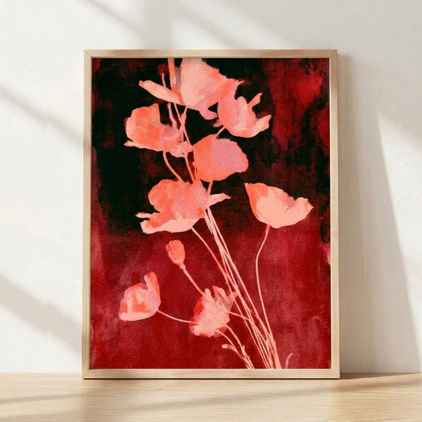 Watercolor poppy art print in deep crimson and coral tones with dark forest green stems, framed on a wall in romantic botanical style.