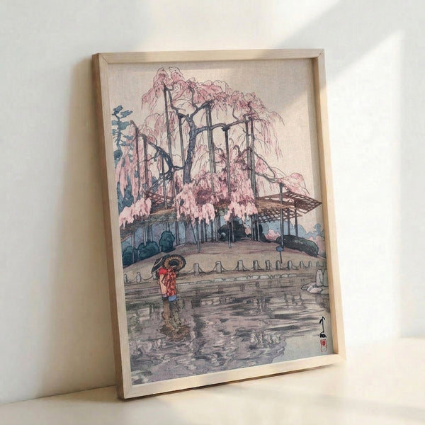 Melancholic garden scene woodblock print showing a willow tree canopy and figure with umbrella beside a pond, combining serene Japanese aesthetics with warm cream and dark brown details.