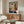 Somber portrait poster featuring a grieving figure in shades of blue and brown, depicted with psychological depth and expressionistic, gestural mark-making.