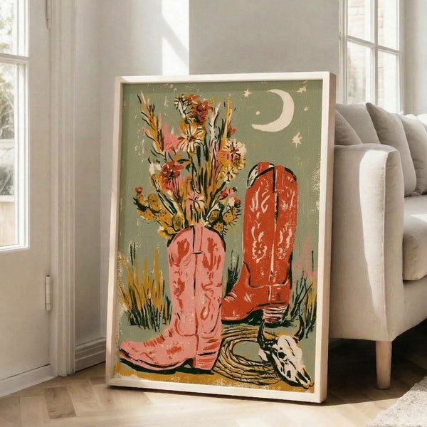 Western-themed art print with nostalgic cowboy boots overflowing with vibrant flowers, accented by whimsical desert elements like cactus and moon against a cream background in warm southwestern colors.
