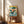 Peaceful yet adventurous retro ocean print showing a majestic whale with a delicate bonsai tree, set against navy and teal waters with coral accents, clouds, and birds in flight.