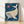 Framed boho whale poster featuring a gentle whale surrounded by a glowing sun, stars, and ocean seaweed in navy, cream, coral, and sage green tones.