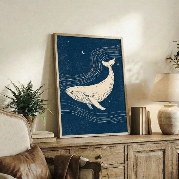 Serene ocean-themed art print featuring a whale in simple line work under a glowing crescent moon surrounded by white stars on navy background.