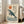Zen-inspired poster showcasing a serene whale beneath rolling waves and glowing sun in pale gray, cream, teal-blue, and rust-orange palette.