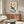 Japandi wall art featuring a contemplative whale swimming beneath sun and waves, rendered in soft minimalist style with rust-orange and teal-blue accents.