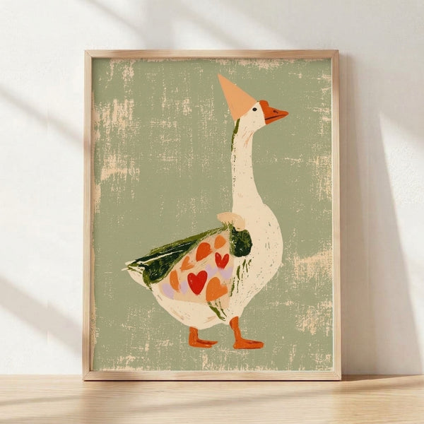 Whimsical folk art print of a silly goose with a heart-shaped wing, surrounded by flowers and leaves in sage green, cream, terracotta, and olive tones, framed on a wall.