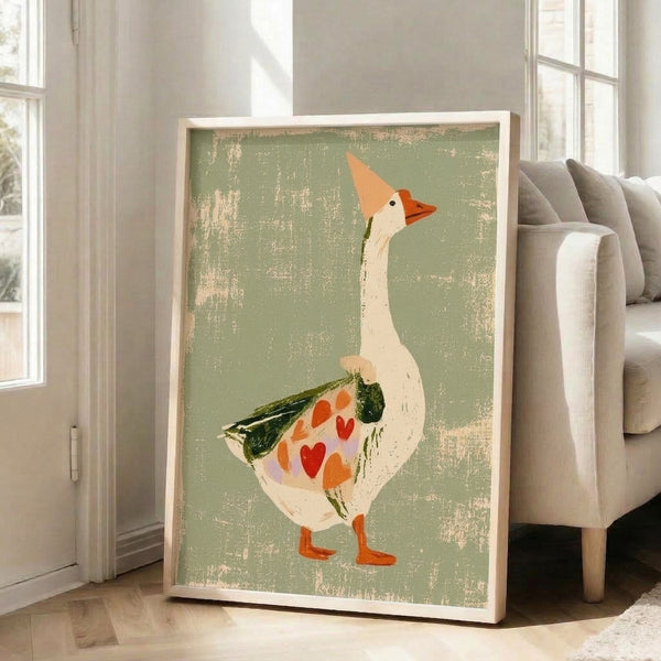 Charming cottagecore-style bird illustration featuring a playful goose with a red heart wing and botanical details in warm, muted earth tones, displayed as a framed poster.