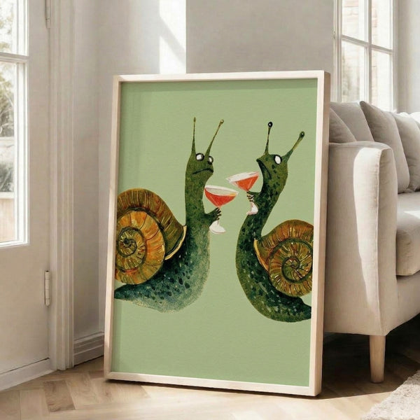 Quirky framed art print featuring snails clinking colorful drinks in a watercolor style, palette of muted sage, warm browns, and coral accents against a cream background.