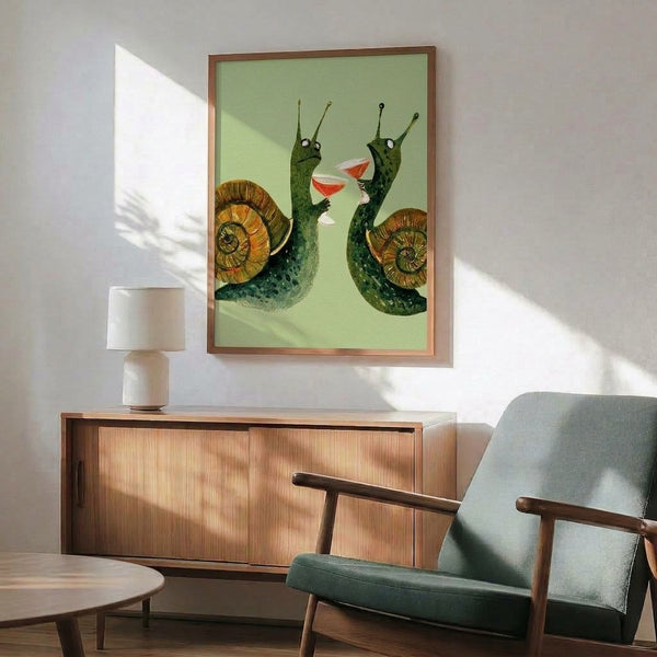 Framed watercolor poster showcasing two snails toasting drinks in soft sage, golden brown, coral red, and cream—quirky and fun wall art with an optimistic mood.