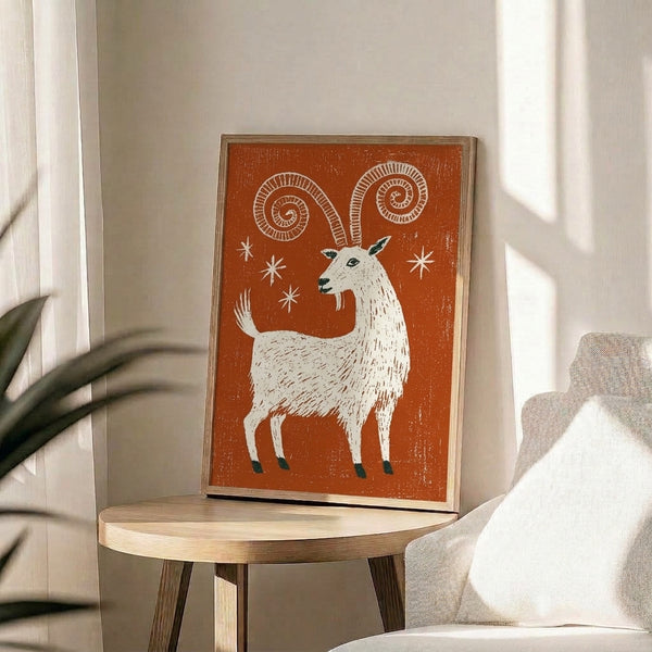 Retro folk art print of a spiraling-horned goat with scattered stars in a cozy palette of rust orange, cream white, and dark teal.